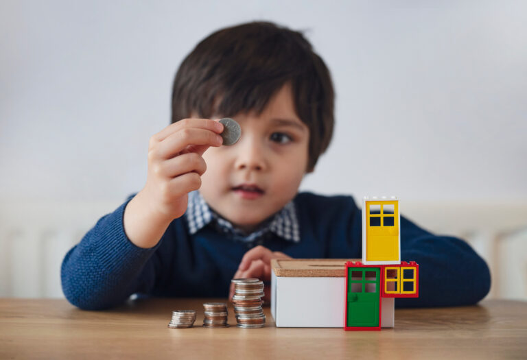 Blurry face of preschool kid showing 10 cents with smiling face