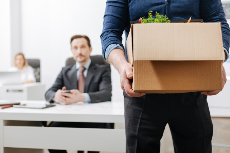 job termination man holding a box of office stuff