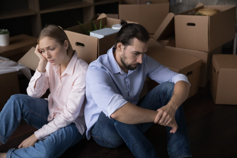 Upset unhappy young couple moving out from home